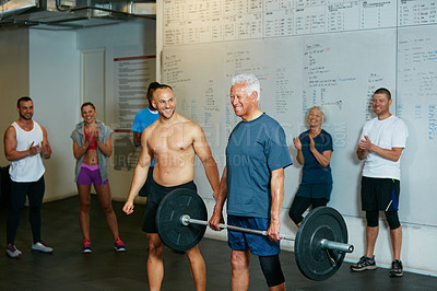 Buy stock photo Shot of a senior man working out with his fitness coach