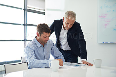 Buy stock photo Shot of two businesspeople having a discussion in a corporate office