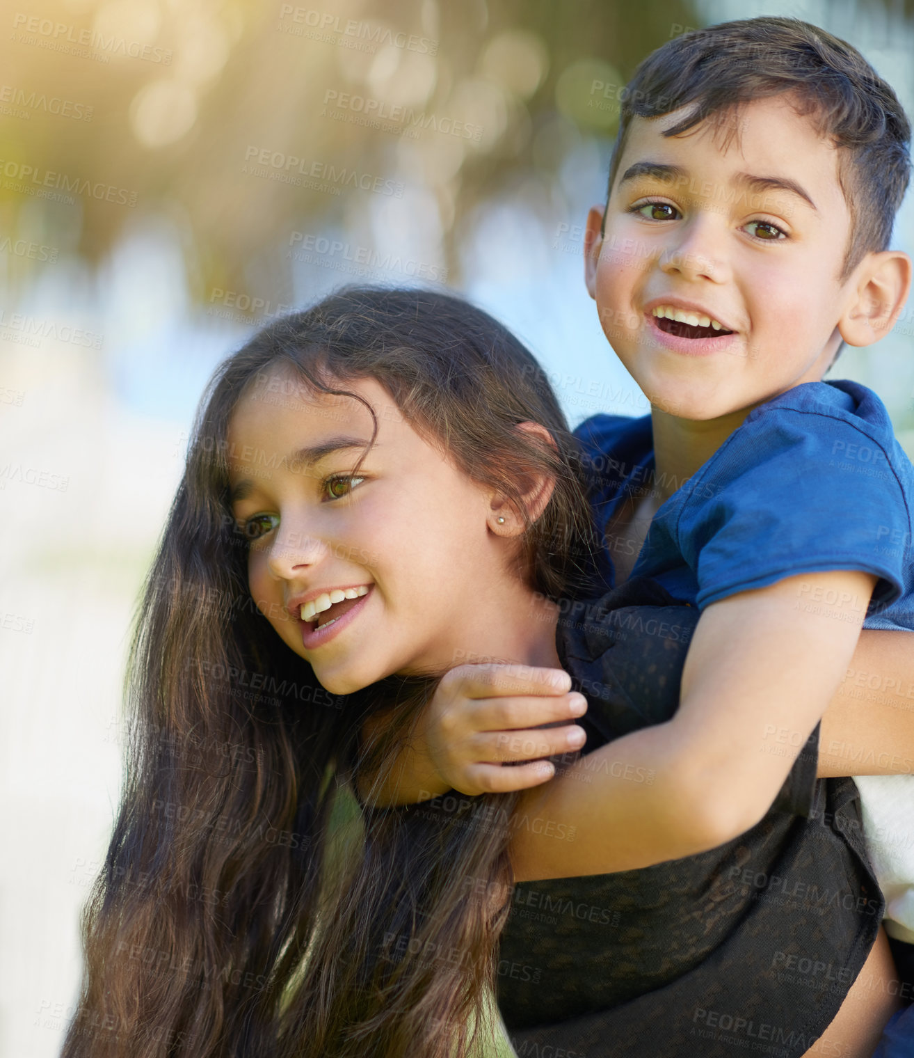 Buy stock photo Shot of a cute little girl giving her brother a piggyback ride at home