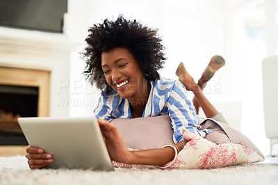 Buy stock photo Woman, home and happy on tablet with lying on floor for social media post and entertainment. Female person, living room and smile with streaming service or website for funny videos and memes