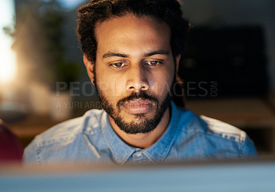 Buy stock photo Cropped shot of a young designer working late on a computer in an office