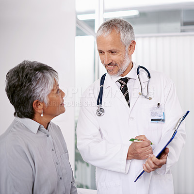 Buy stock photo Elderly man doctor with patient, clipboard for information and medical forms during consultation. Healthcare, old woman at checkup and health insurance with communication and help at doctors office