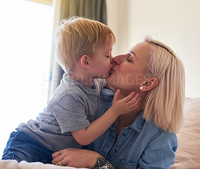 Buy stock photo Mom, young boy and kiss in family home for love, happiness and care in apartment. Woman, child and mothers day in bedroom with hug, gratitude and parent for bonding and affection in springtime