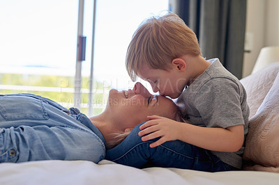 Buy stock photo Cropped shot of a young boy kissing his mother at home