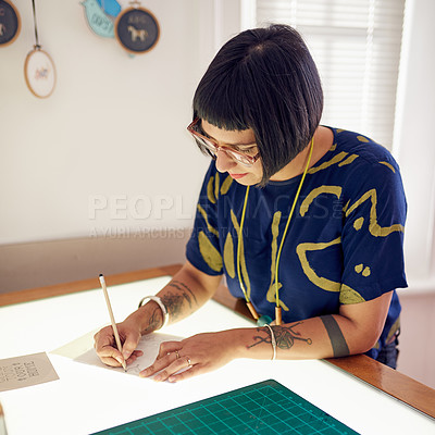 Buy stock photo Shot of a stylish young designer at working on a light table in her studio