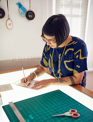 Buy stock photo Shot of a stylish young designer at working on a light table in her studio