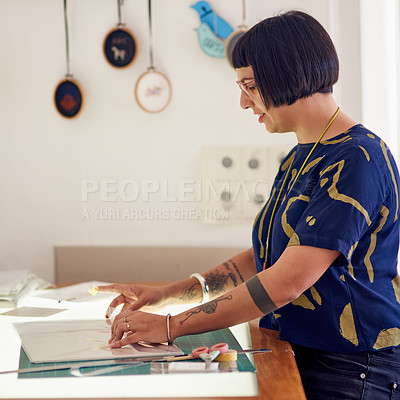 Buy stock photo Shot of a stylish young designer at working at a table in her studio