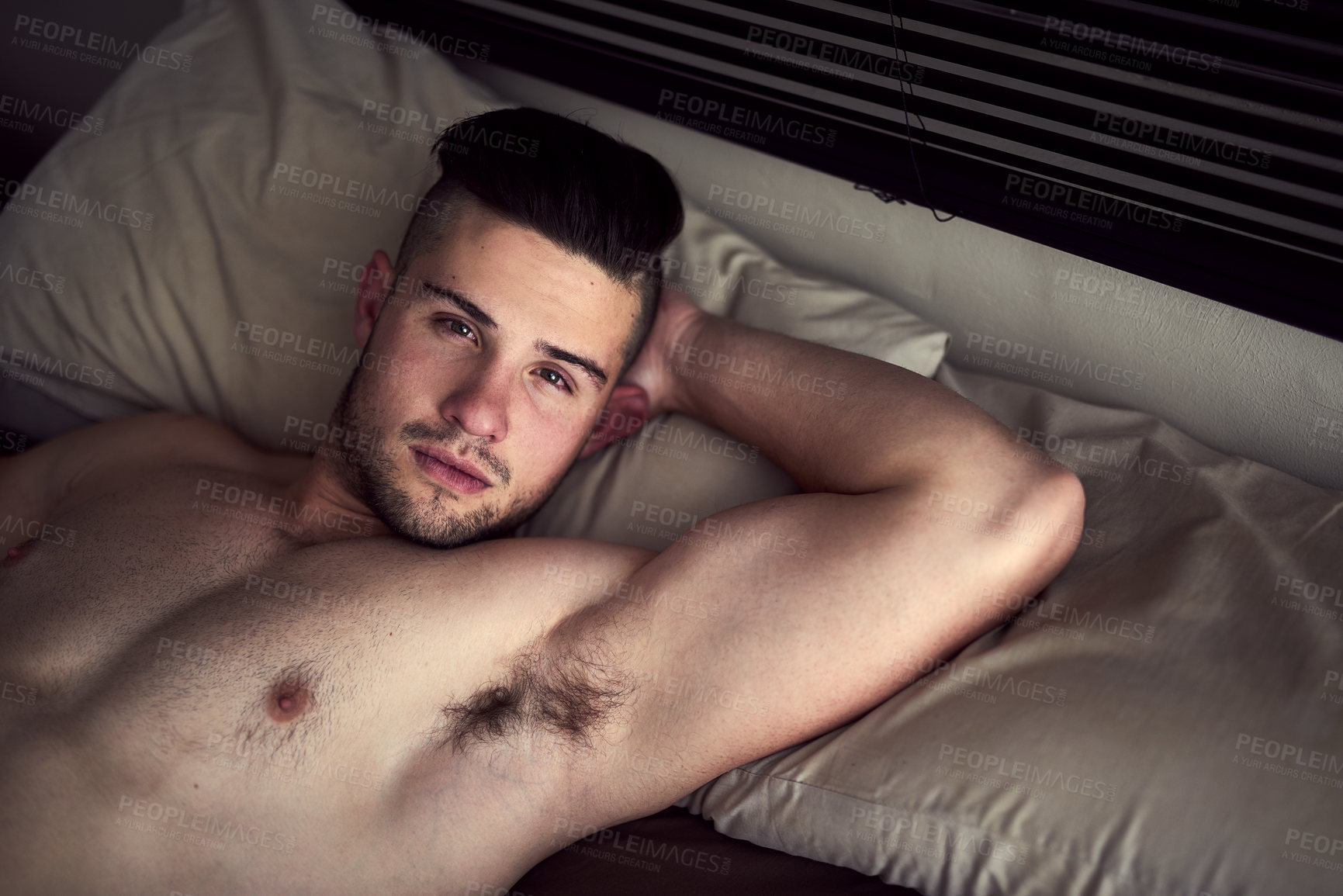 Buy stock photo Portrait, chest and body of man on bed for relax with weekend break, confidence and pillow for rest. Topless, sexy and male person on mattress in home with skin for lazy Sunday, muscle and wellness