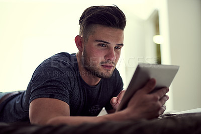 Buy stock photo Internet, tablet and man on bed in home for watching online video with streaming movie and web browsing. Technology, typing and guy on mattress with website for learning language and social media app