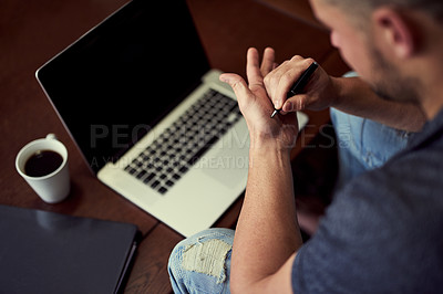 Buy stock photo Laptop, table and man writing on hand for reminder with internet connection, coffee and note for email password. Memory, desk and male freelancer with word for remember, remote work and information