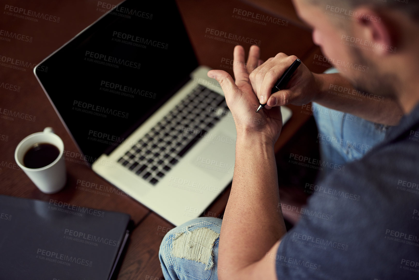 Buy stock photo Laptop, table and man writing on hand for reminder with internet connection, coffee and note for email password. Memory, desk and male freelancer with word for remember, remote work and information