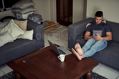 Buy stock photo Businessman, tablet and typing on sofa for remote work, home and relax on break from freelance job. Communication, networking and person on touchscreen for planning, scroll online or sitting in house