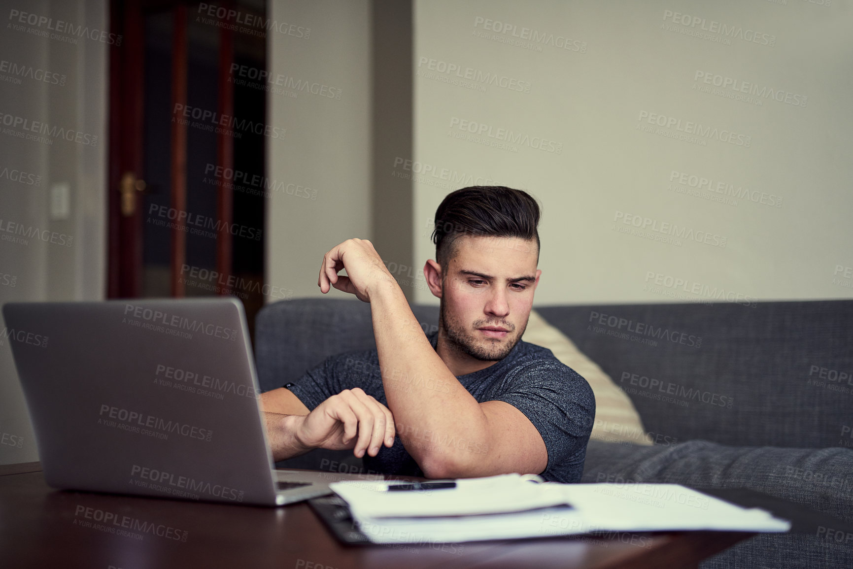 Buy stock photo Man, laptop and table in living room with book, remote work and small online business startup. Technology, freelance or planning from home, paperwork and internet for virtual training or webinar