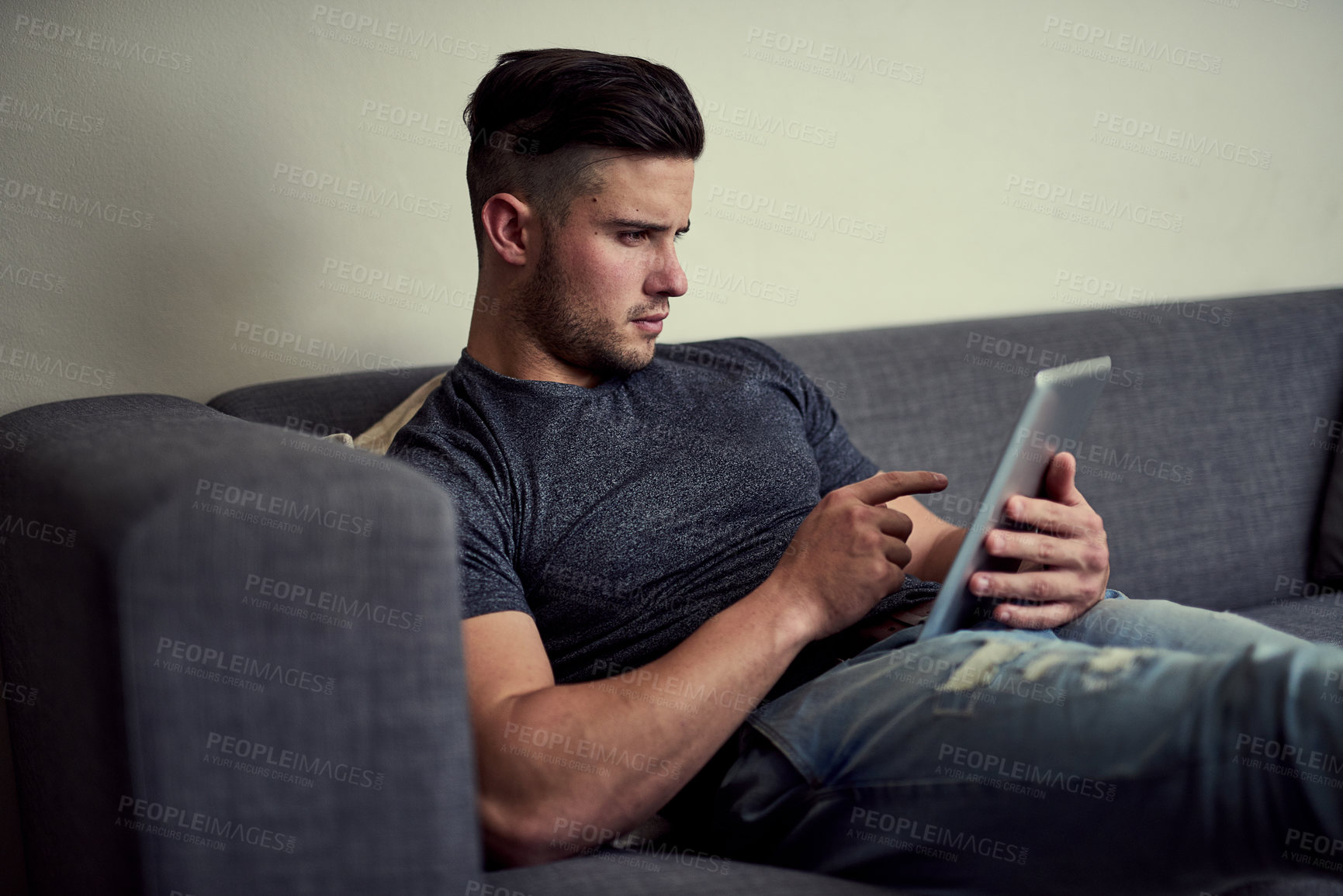 Buy stock photo Man, tablet and social media on weekend sofa, streaming and app subscription for games or movies. Male person, scroll and choice of series on website, online and internet for communication in home