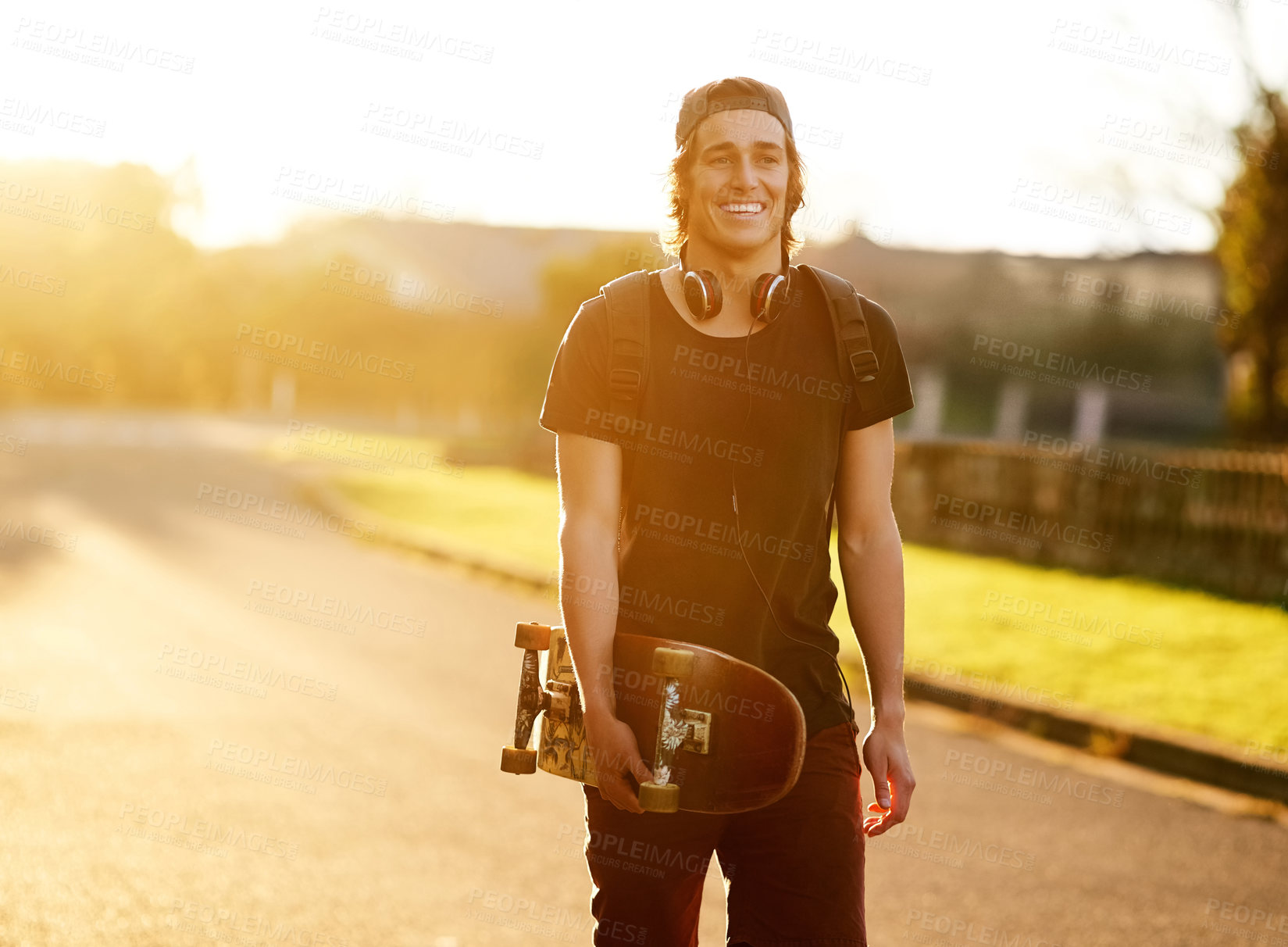 Buy stock photo Portrait of a young man standing with his skateboard outside