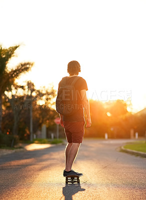 Buy stock photo Young man, back and sports with skateboarding on urban street for travel, exercise and hobby. Male person or athlete and fitness with skating workout in sunshine for freedom, peace and wellness