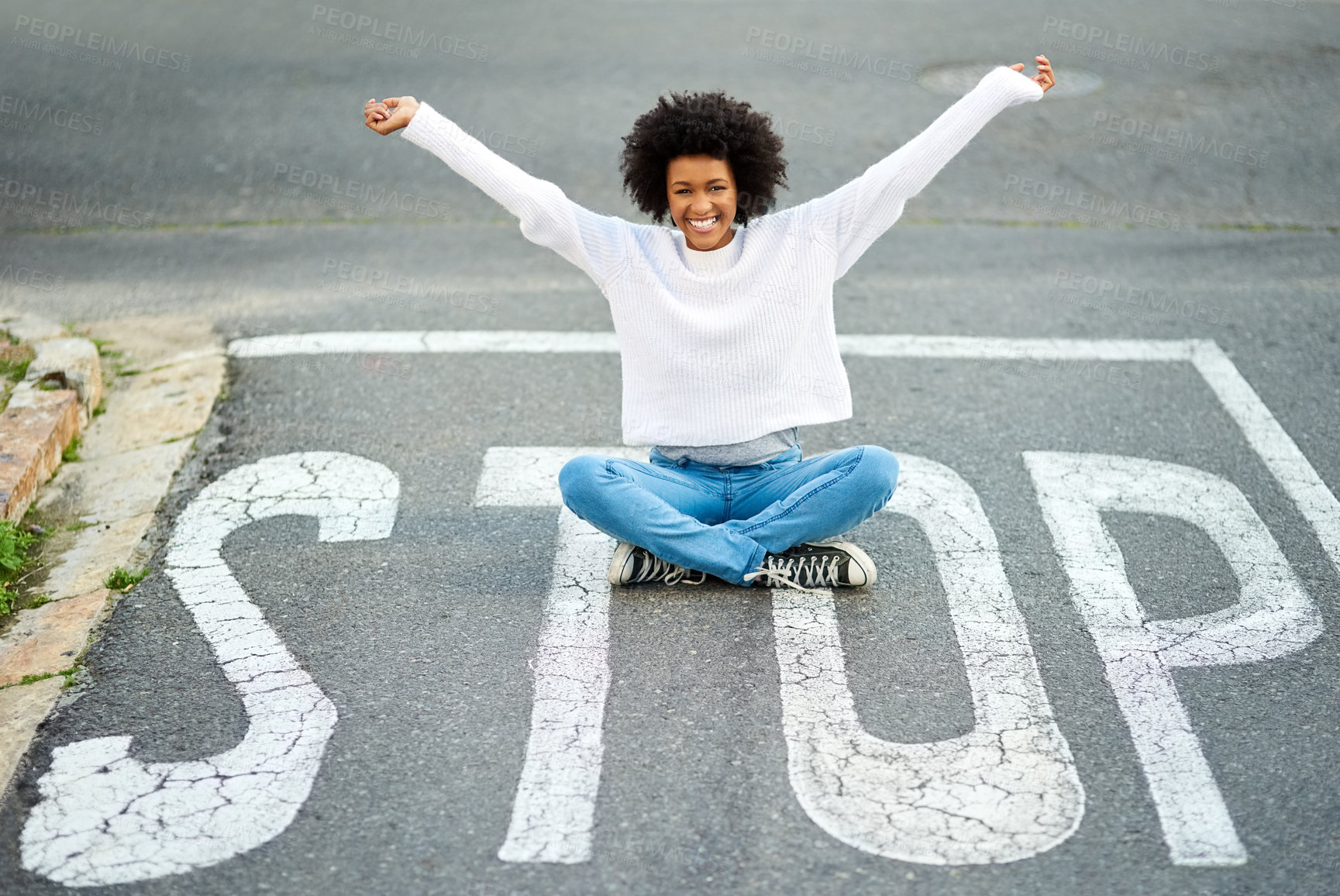 Buy stock photo Woman, road and sitting on stop sign with smile in portrait for memory, travel or tourism on vacation in summer. Girl, person and happy by traffic marking in streetwear, holiday or playful in Atlanta