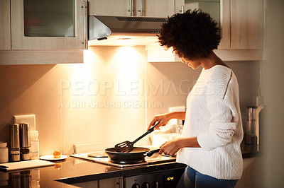 Buy stock photo Black woman, pan and cooking on stove in home, frying and meal preparation in kitchen. Female person, apartment and nutrition in food, diet and wellness for cuisine on gas for dinner routine in house