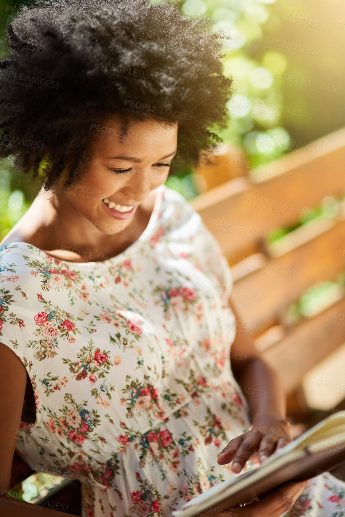 Buy stock photo African woman, smile and reading with book on park bench to relax on vacation with story, language and learning. Girl, person and happy with novel, literature and holiday with sunshine in Atlanta