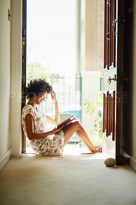 Buy stock photo Black woman, happy and reading as hobby, relax and peace for learning, fun or leisure in home on floor with novel. Female person, entertainment and scholarship in literature for story, poetry or book