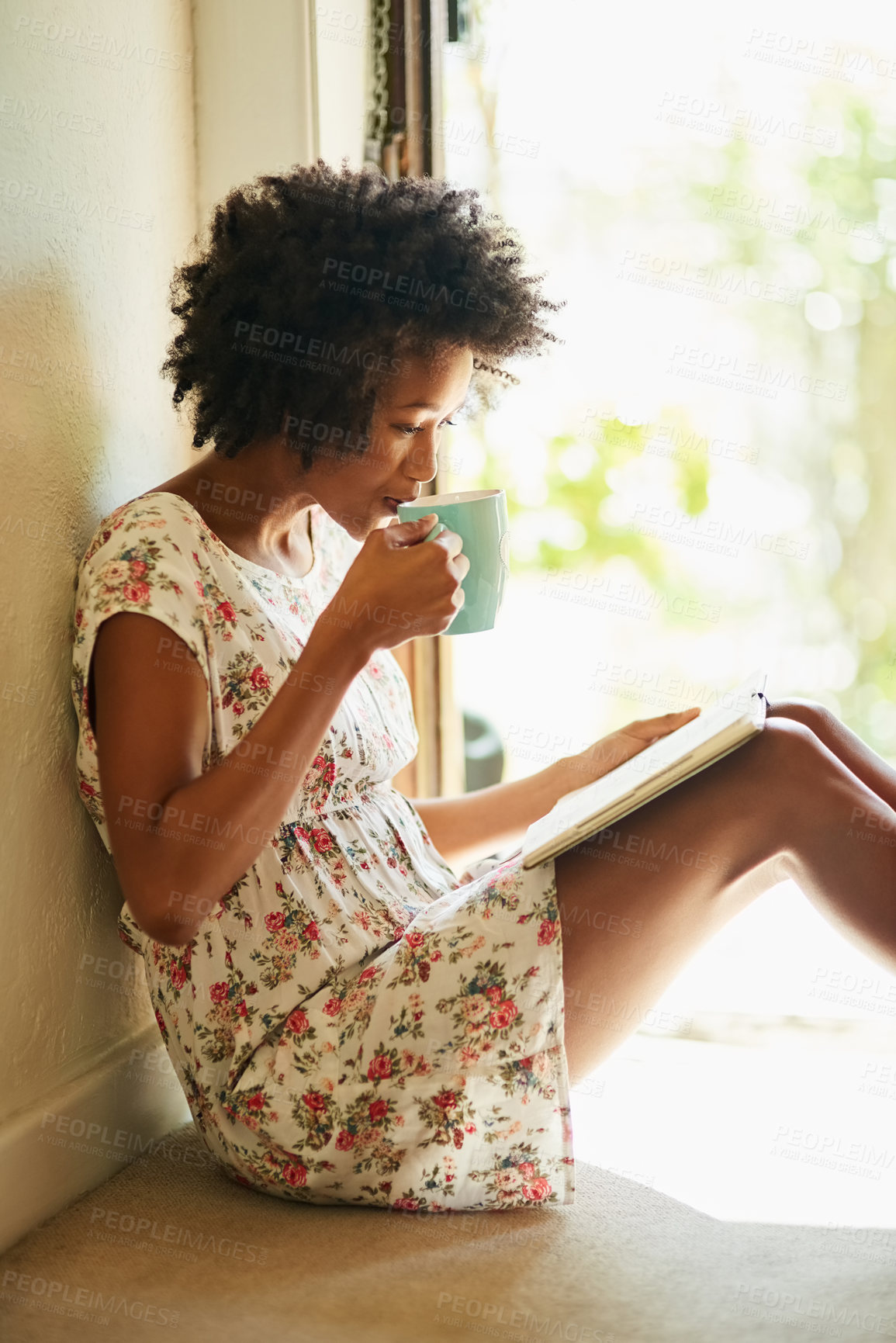 Buy stock photo Woman, read and book in home with coffee, door way and sitting on floor for comfort with literature or novel for hobby. Fiction, fantasy and knowledge or information, apartment and relax weekend