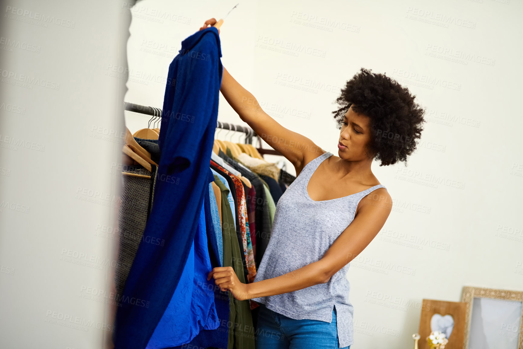 Buy stock photo Black woman, clothes and choice at wardrobe in home, getting ready and morning preparation for work. Closet, fashion and girl with decision in bedroom for fabric and thinking of textile for dressing