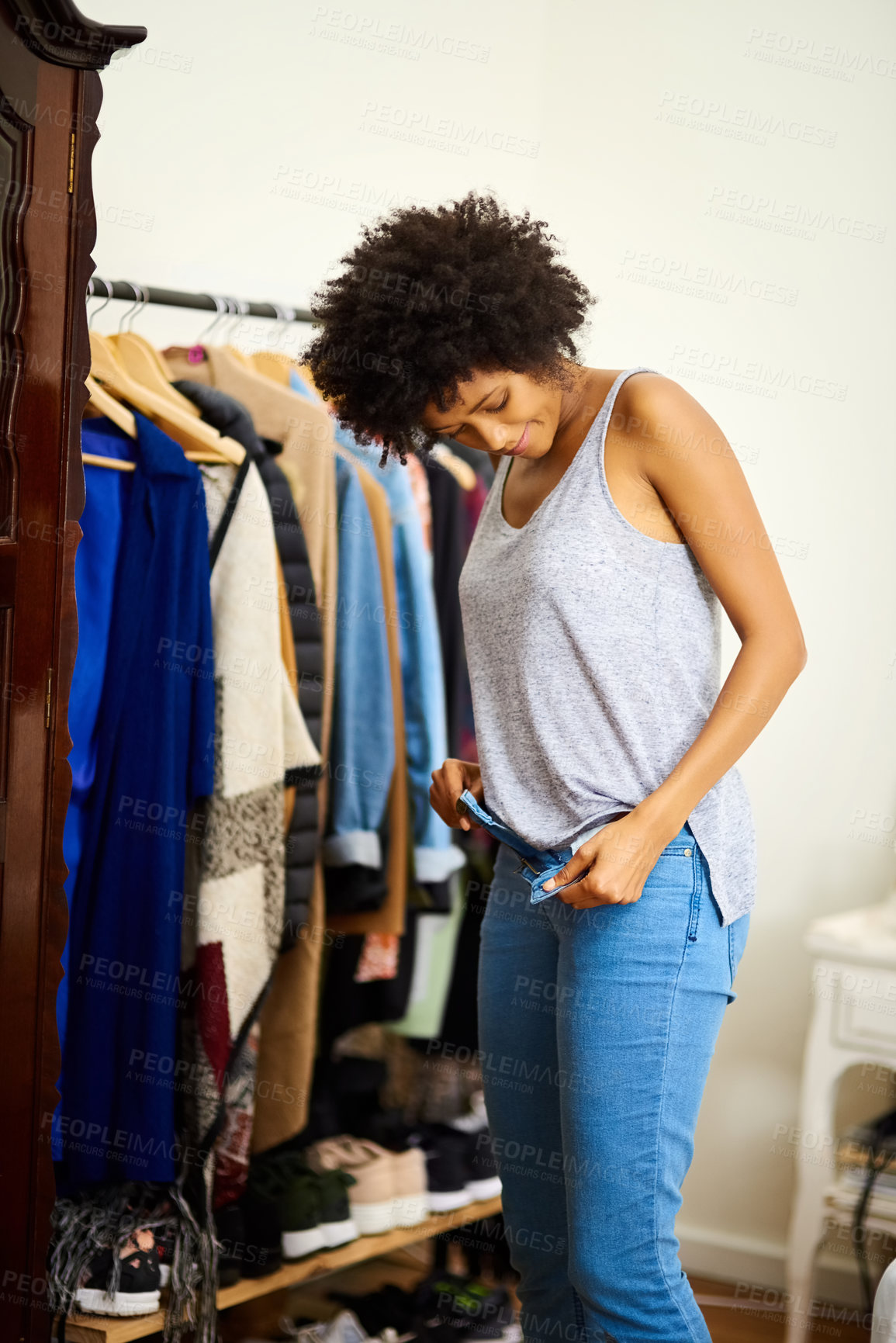 Buy stock photo Fashion, clothes and black woman dressing in home in bedroom with outfit in closet for collection. Choice, morning and casual girl in apartment trying on jeans or denim for getting ready for style