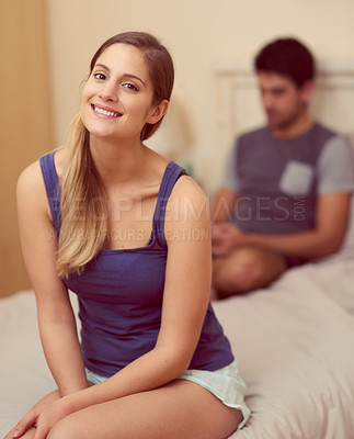 Buy stock photo Portrait of a happy young woman sitting on her bed at home