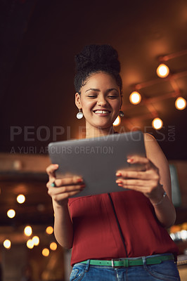 Buy stock photo Cropped shot of a young woman using a digital tablet in a cafe