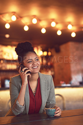 Buy stock photo Cropped shot of a young businesswoman talking on a cellphone in a cafe