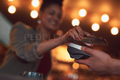 Buy stock photo Closeup shot of a woman paying using NFC technology in a cafe