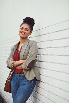 Buy stock photo Portrait of a beautiful young woman standing against a brick wall
