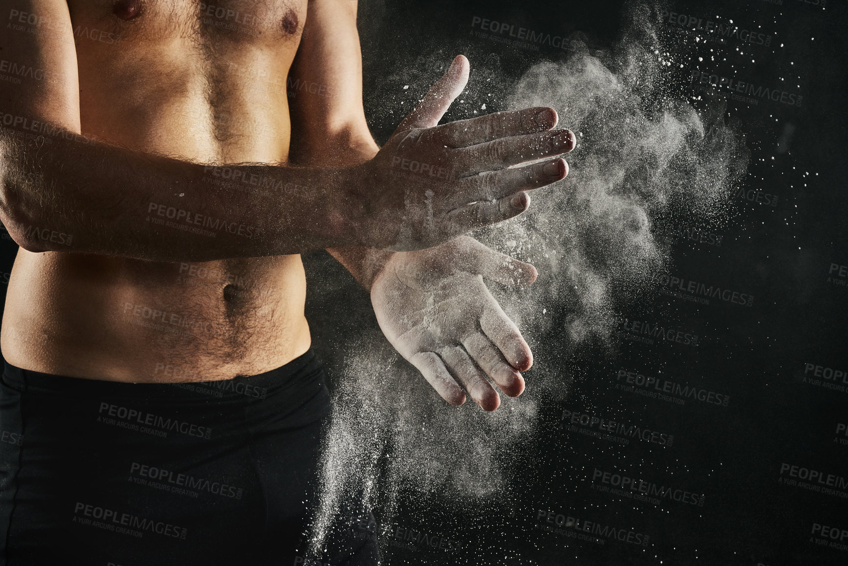 Buy stock photo Fitness, hands and chalk in studio for exercise, weightlifting and start or gymnastics. Male gymnast, powder and preparation for workout, topless or muscular on black background with arm bands