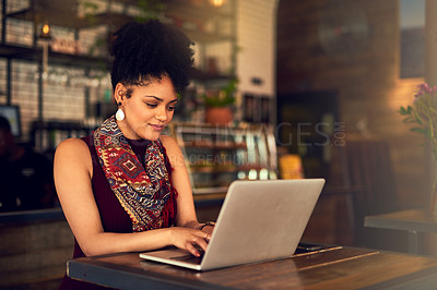 Buy stock photo Cropped shot of an attractive young woman working on her laptop in a cafe