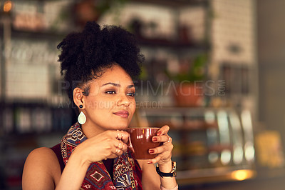 Buy stock photo Cropped shot of an attractive young woman enjoying a cup of coffee in a cafe