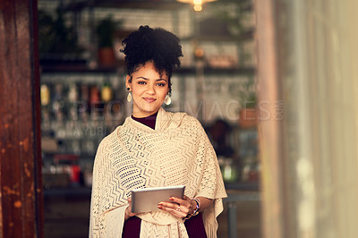 Buy stock photo Portrait of an attractive young woman using a digital tablet in a cafe