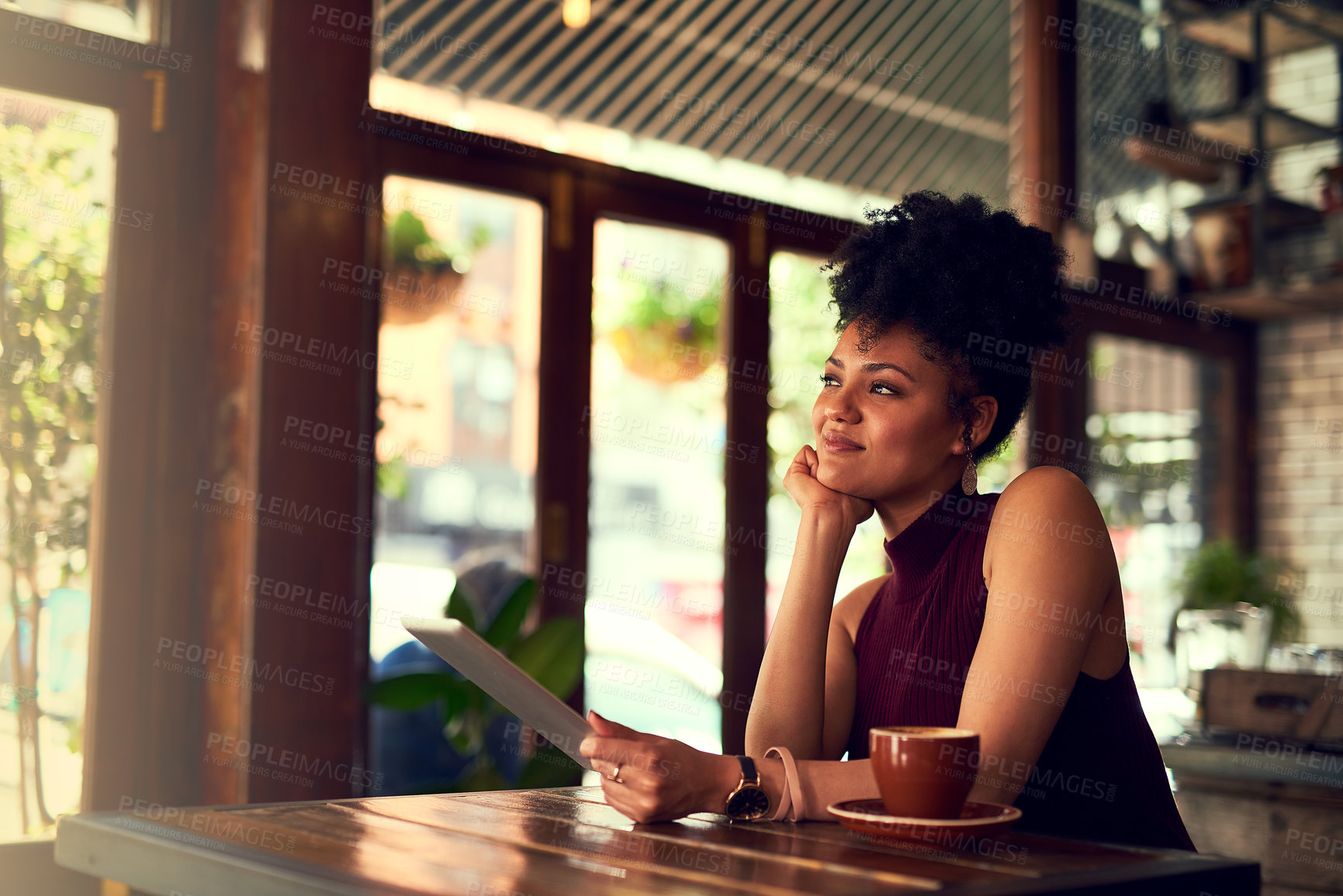 Buy stock photo Cropped shot of an attractive young woman using a digital tablet in a cafe