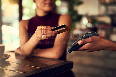 Buy stock photo Closeup shot of a woman paying using NFC technology in a cafe