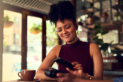Buy stock photo Cropped shot of a young woman paying using NFC technology in a cafe