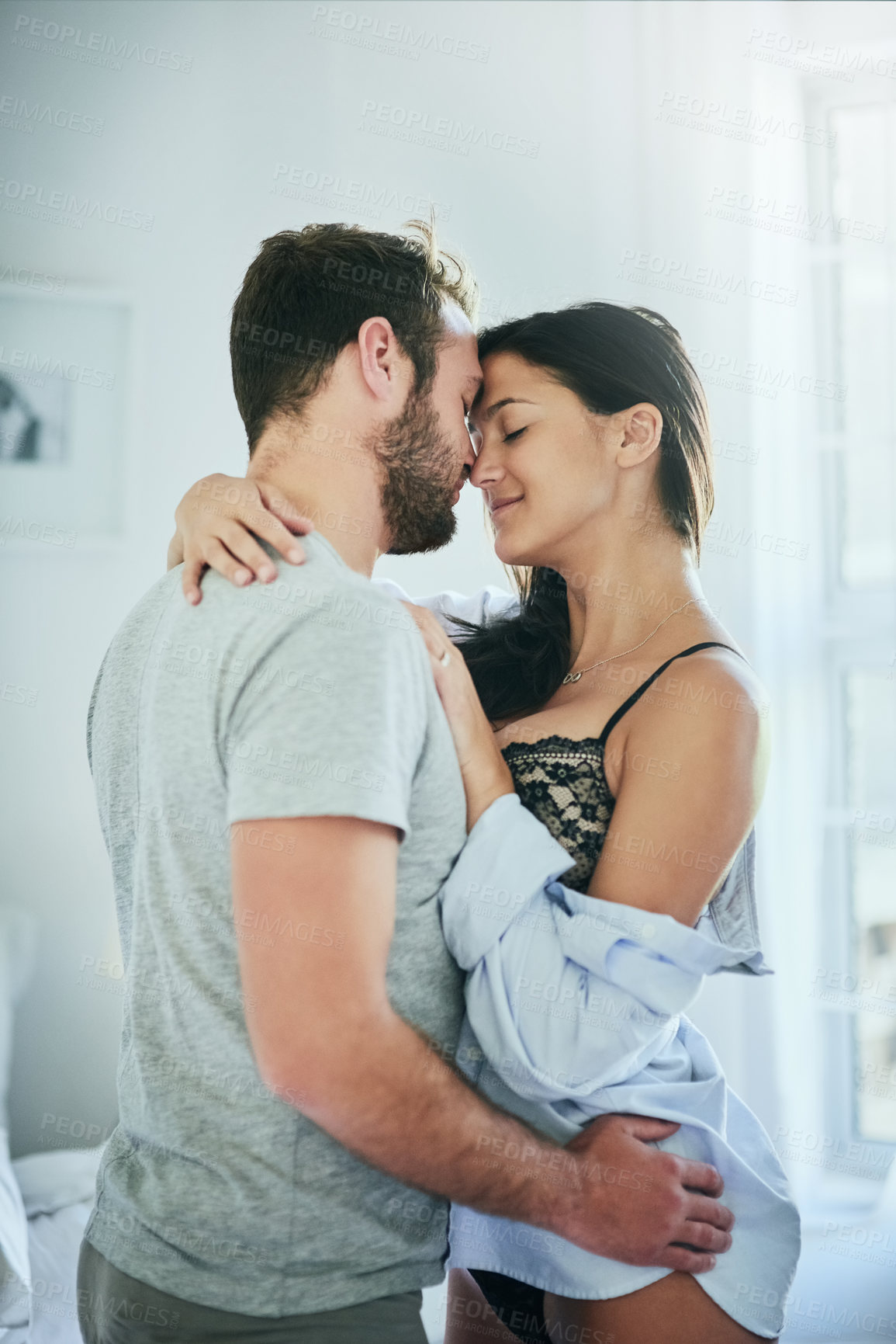 Buy stock photo Love, affection and couple in bed with hug, romance and and morning bonding in apartment. Relationship, man and woman in bedroom with intimate embrace, passion and relax with care on weekend in home