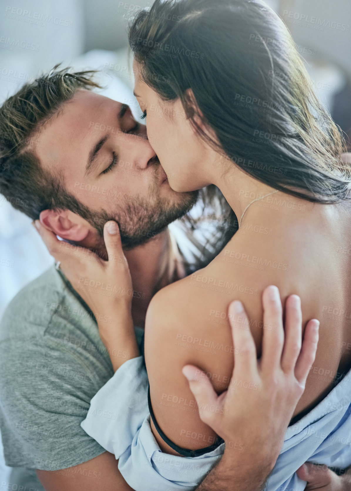 Buy stock photo Love, romance and couple in bed with kiss, affection and and morning bonding in apartment. Relationship, man and woman in bedroom with intimate embrace, passion and relax with care on weekend in home