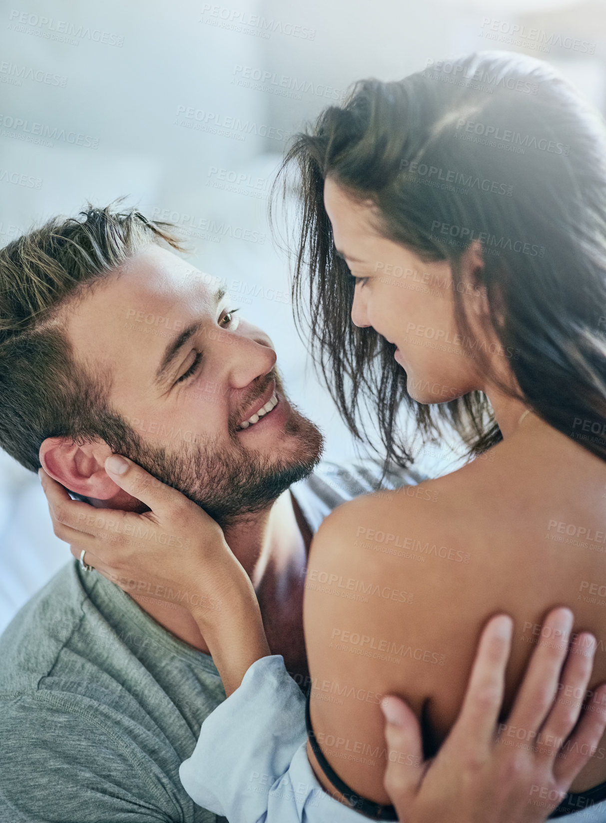 Buy stock photo Love, romance and couple in bed with smile, affection and morning bonding in apartment. Relationship, man and woman in bedroom with intimate embrace, passion and relax with care on weekend in home