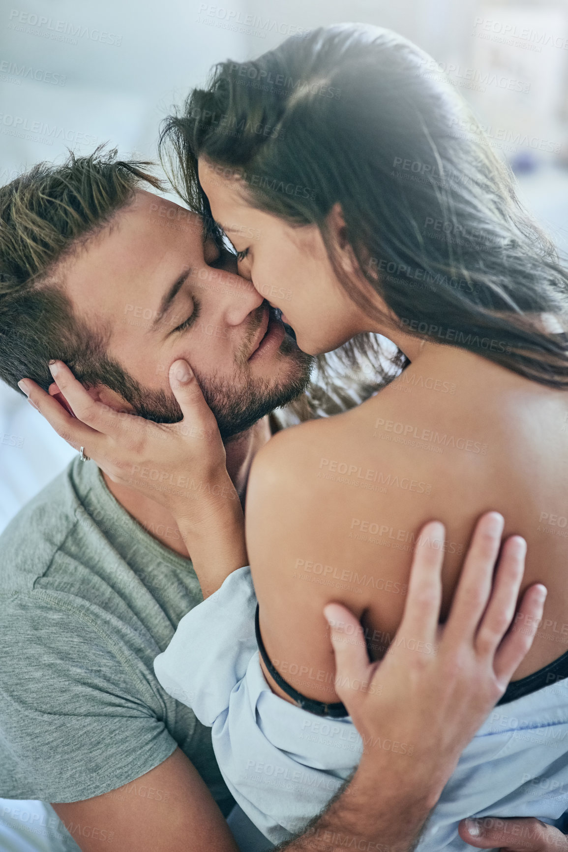 Buy stock photo Love, kiss and intimate couple in bed with romance, affection and morning bonding in apartment. Relationship, man and woman relax in bedroom with happy embrace, passion and care on weekend in home