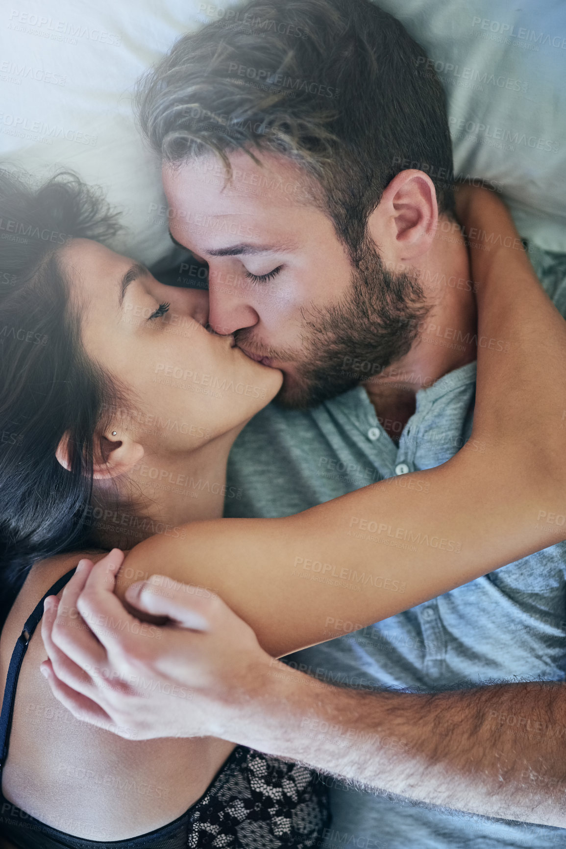 Buy stock photo Passion, man and woman in bed with kiss, romance and morning bonding in apartment. Relationship, affection and couple in bedroom with intimate embrace, love and relax with care on weekend in home