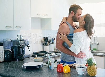 Buy stock photo Cooking, kiss and couple in kitchen with food for meal prep for dinner, supper and lunch in home. Relationship, dating and man and woman embrace with healthy ingredients for bonding, love and romance