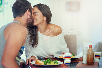 Buy stock photo Breakfast, home and couple kiss with food, happy and love together with marriage at table. Hungry, eating and woman with eggs and cooking in a new house with anniversary, romance and care with smile