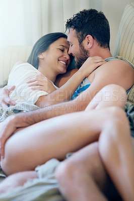 Buy stock photo Couple, love and cuddle on couch in home on holiday, weekend or relax with peace in apartment. People, hug and embrace on sofa with trust, care and support in marriage and happy relationship