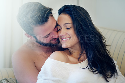 Buy stock photo Couple, cuddle and kiss on couch in home on holiday, weekend or relax with peace in apartment. People, love and hug on sofa with trust, care and support in marriage or happy relationship in morning