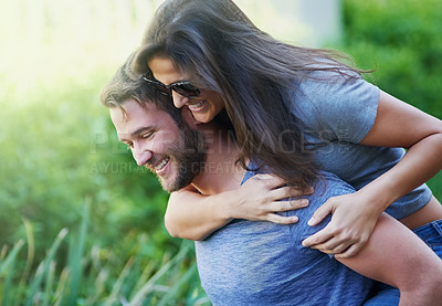 Buy stock photo Couple, piggy back and happy at park in summer with nature, holiday or playful adventure with love. Man, woman and excited with comic game, memory and laugh together on walk with sunshine in garden