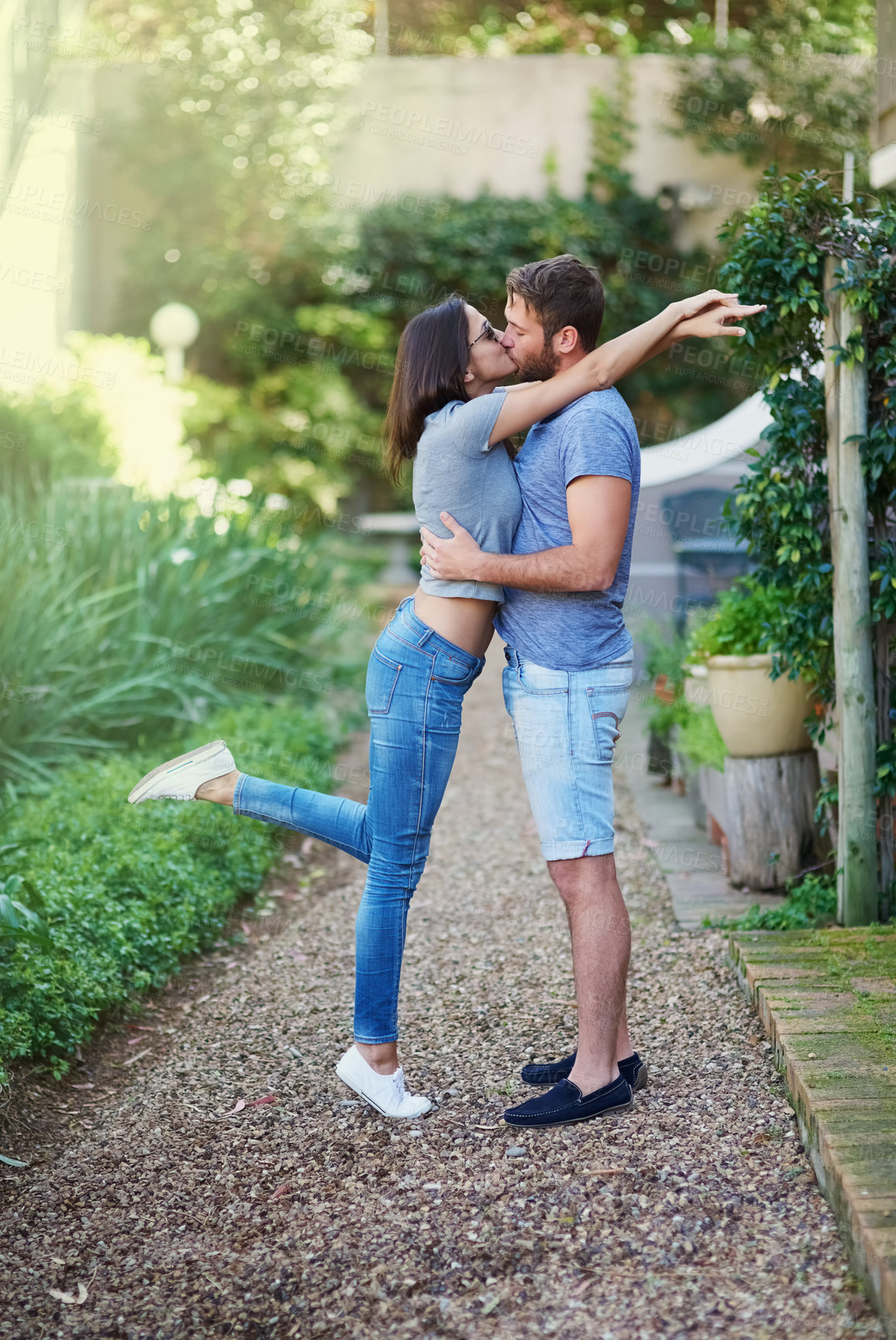 Buy stock photo Couple, hug and kiss in garden, outdoor and connection with love, romance and vacation in spring. Man, woman and embrace with care, kindness and bonding on dirt path in backyard in summer sunshine